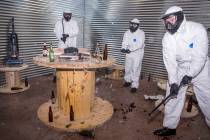 Las Vegas residents, from left, Cisco Meija, Amber Carroll and Brandon Fleisher destroy glass b ...