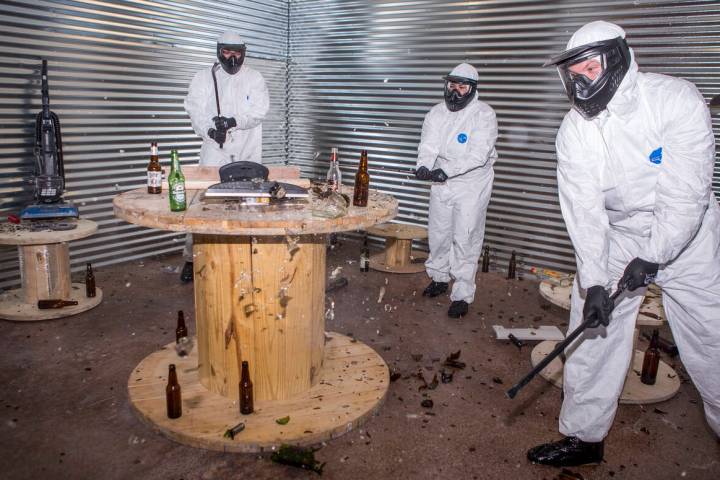 Las Vegas residents, from left, Cisco Meija, Amber Carroll and Brandon Fleisher destroy glass b ...