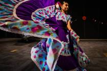 A dancer from Danzantes del Puerto, a local folklorico dance group, dances during a performance ...