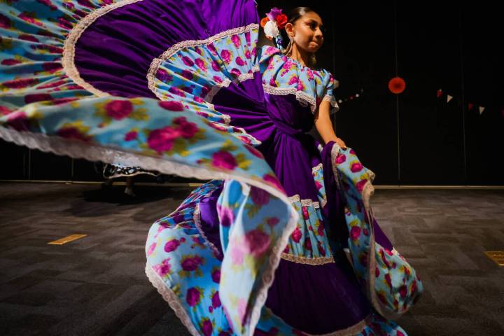 A dancer from Danzantes del Puerto, a local folklorico dance group, dances during a performance ...