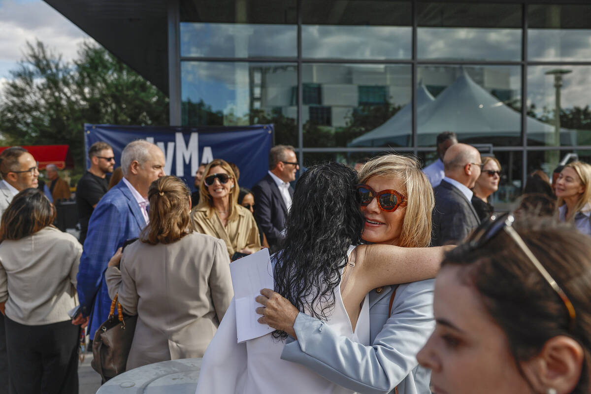Guests hug and chat outside Grand Central Galleries in Symphony Park during the Las Vegas Museum of Art groundbreaking on Sept. 28, 2026