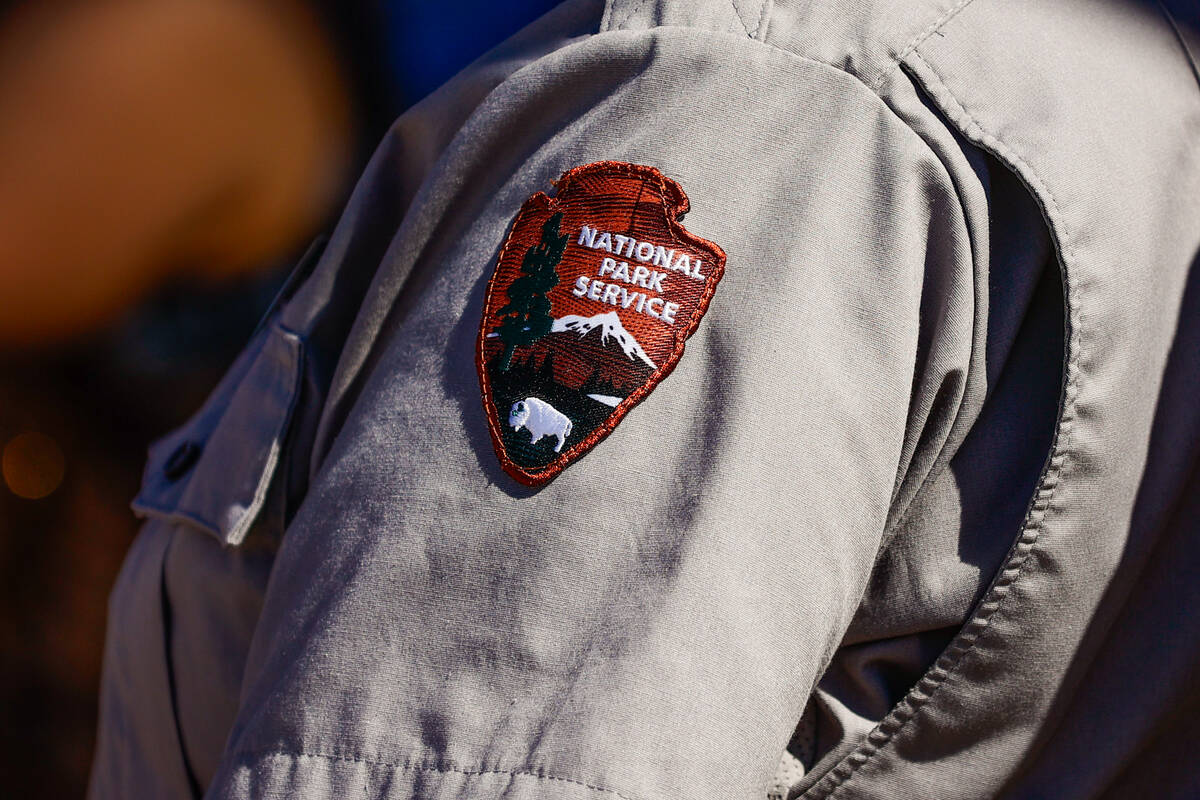 A National Park Service badge is seen on the sleeve of a park ranger’s uniform at the Travel ...