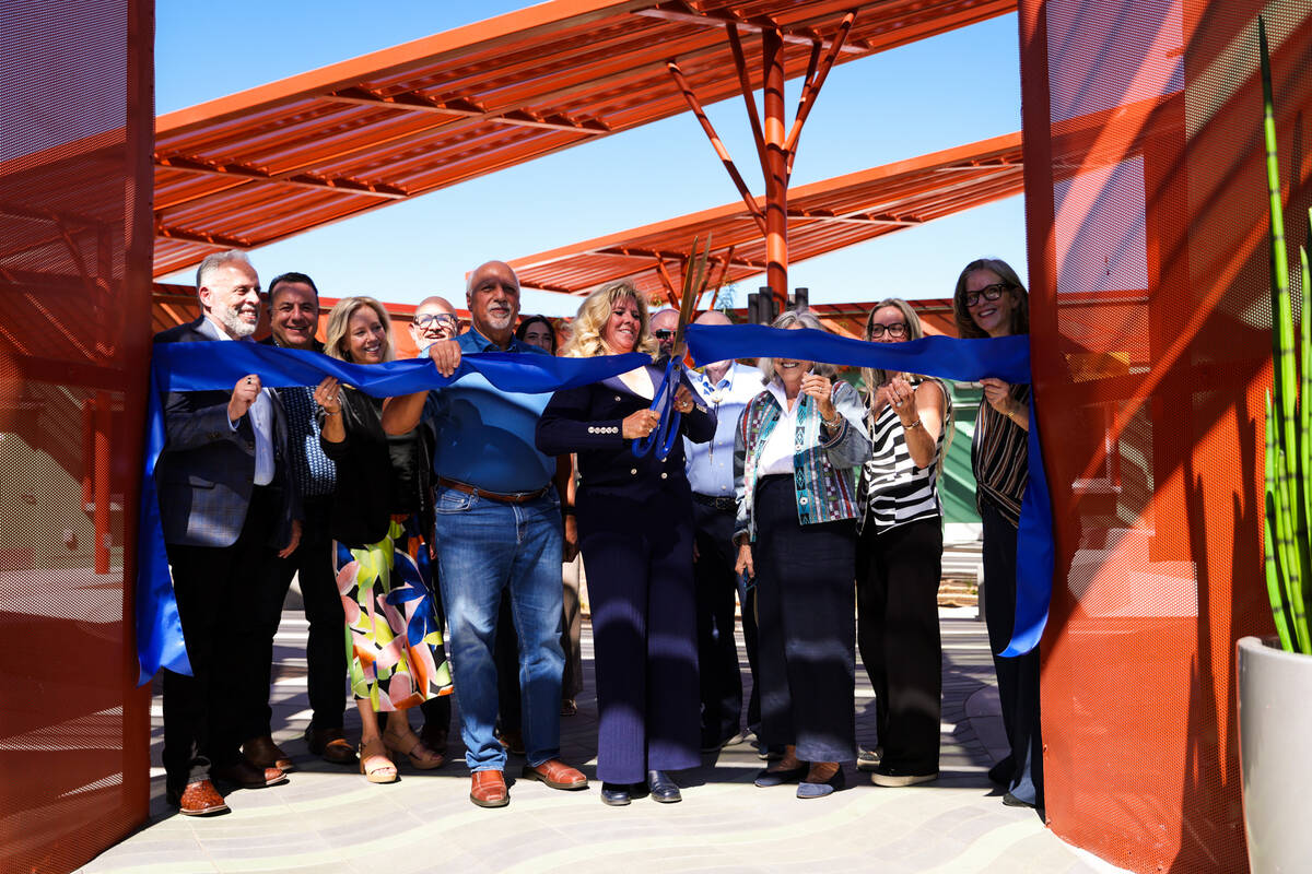 The CEO of the Boulder City Chamber of Commerce, Jill Rowland-Lagan, cuts the ribbon to officia ...