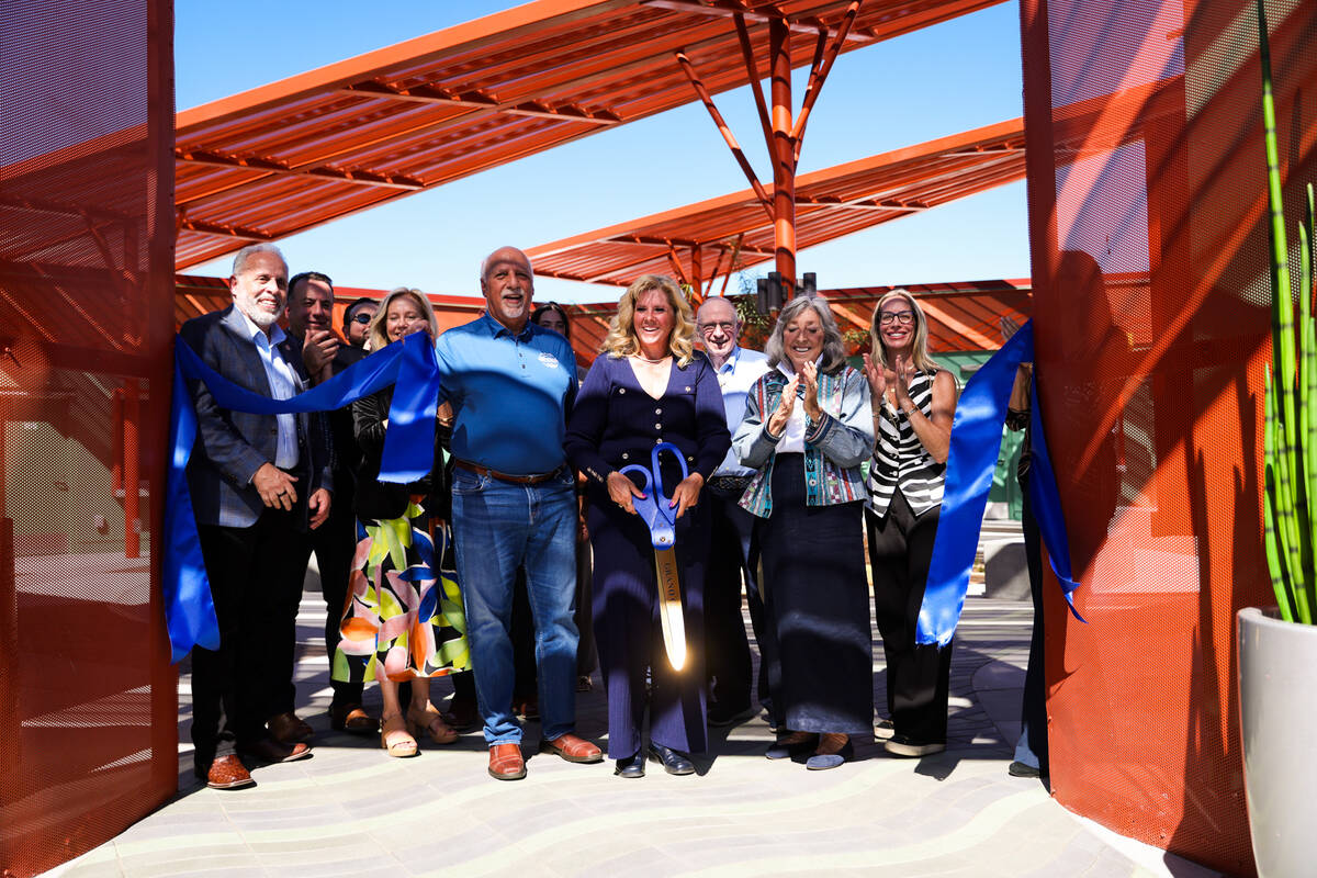 The CEO of Boulder City Chamber of Commerce, Jill Rowland-Lagan, cuts the ribbon to officially ...