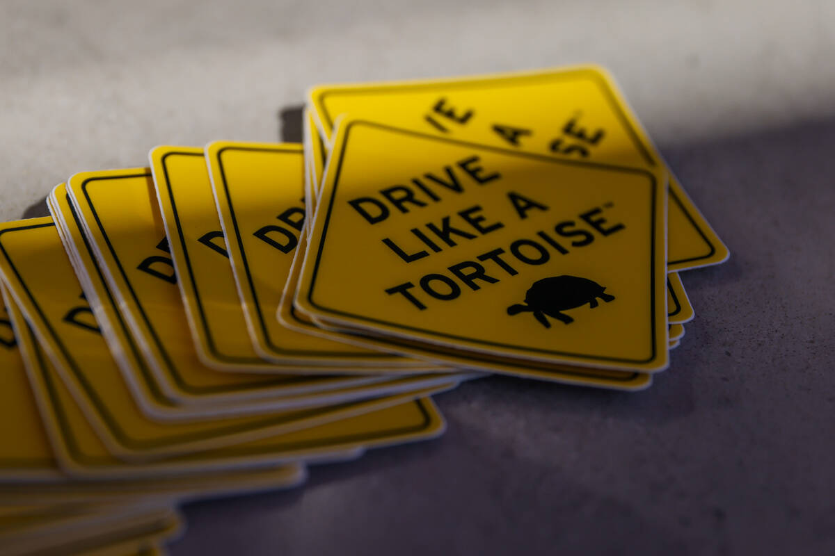 “Drive like a tortoise” stickers being offered to visitors at the Travel Nevada Adventure C ...