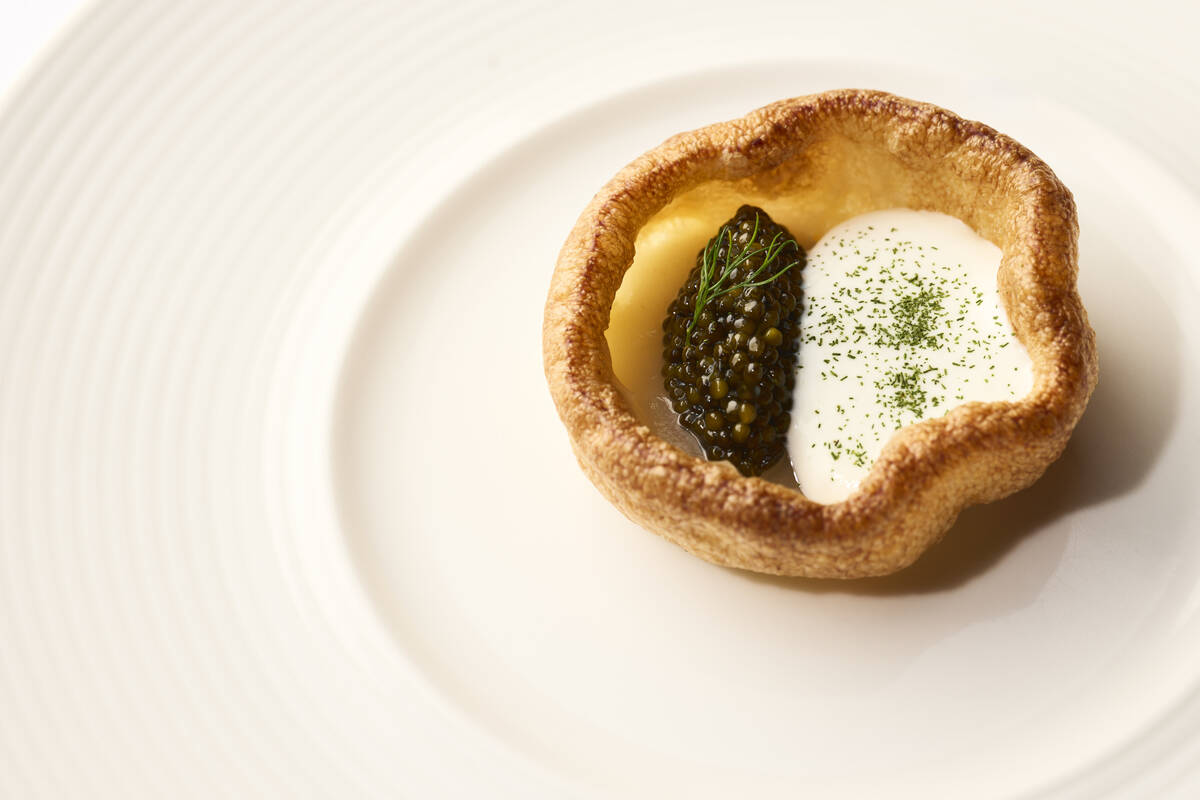 An amuse-bouche of Petrossian Tsar Imperial Daurenki Caviar in a miniature Dutch baby with Bosc ...