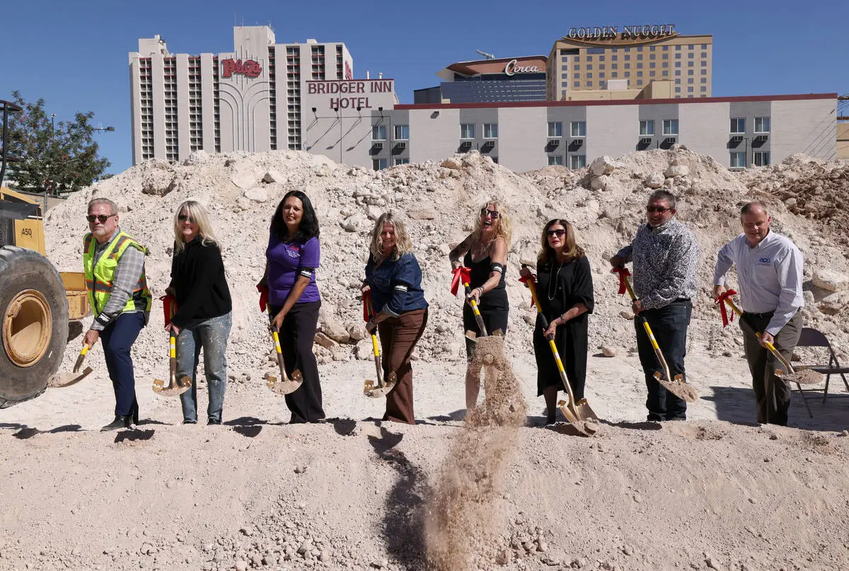 Hogs & Heifers Saloon owner MIchelle Dell, fourth from right, laughs as she accidentally ju ...