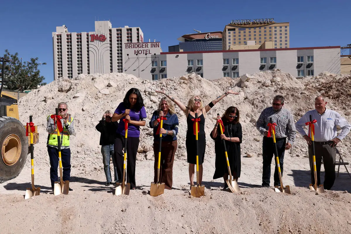 Hogs & Heifers Saloon owner MIchelle Dell, fourth from right, celebrates during a groundbre ...