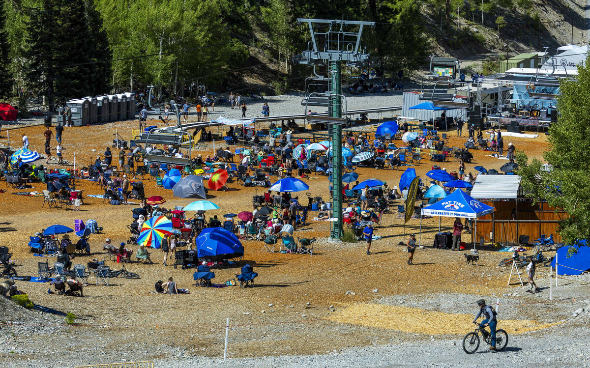 People sit and relax before the stage during the Music on the Mountain outdoor concert series a ...