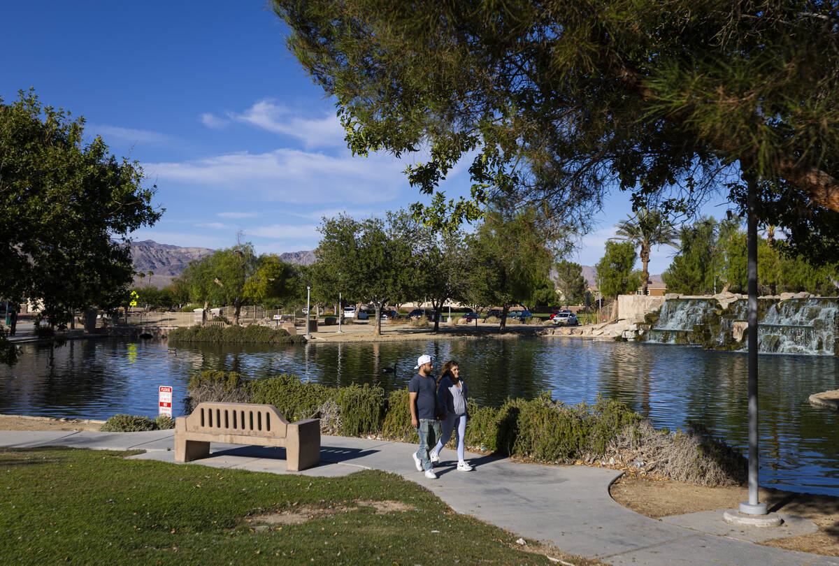 People walk by a pond at Aliante Nature Discovery Park on Sunday, Sept. 20, 2026, in North Las ...