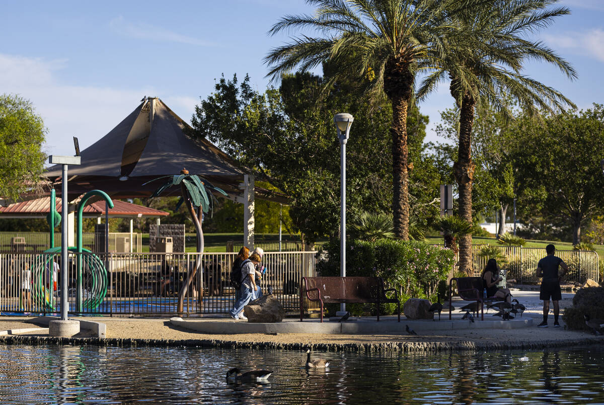 People walk by a pond at Aliante Nature Discovery Park on Sunday, Sept. 20, 2026, in North Las ...