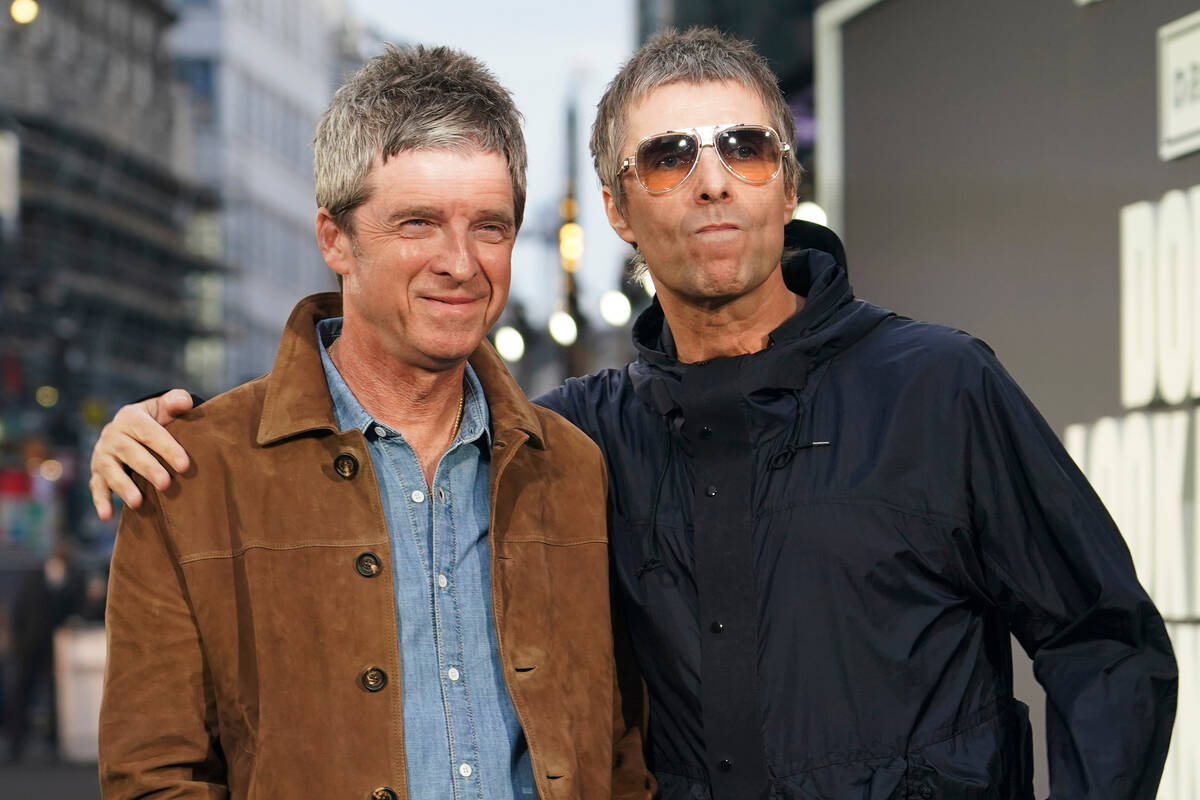 Liam Gallagher, right, and Noel Gallagher pose for photographers upon arrival at the 'Oasi ...